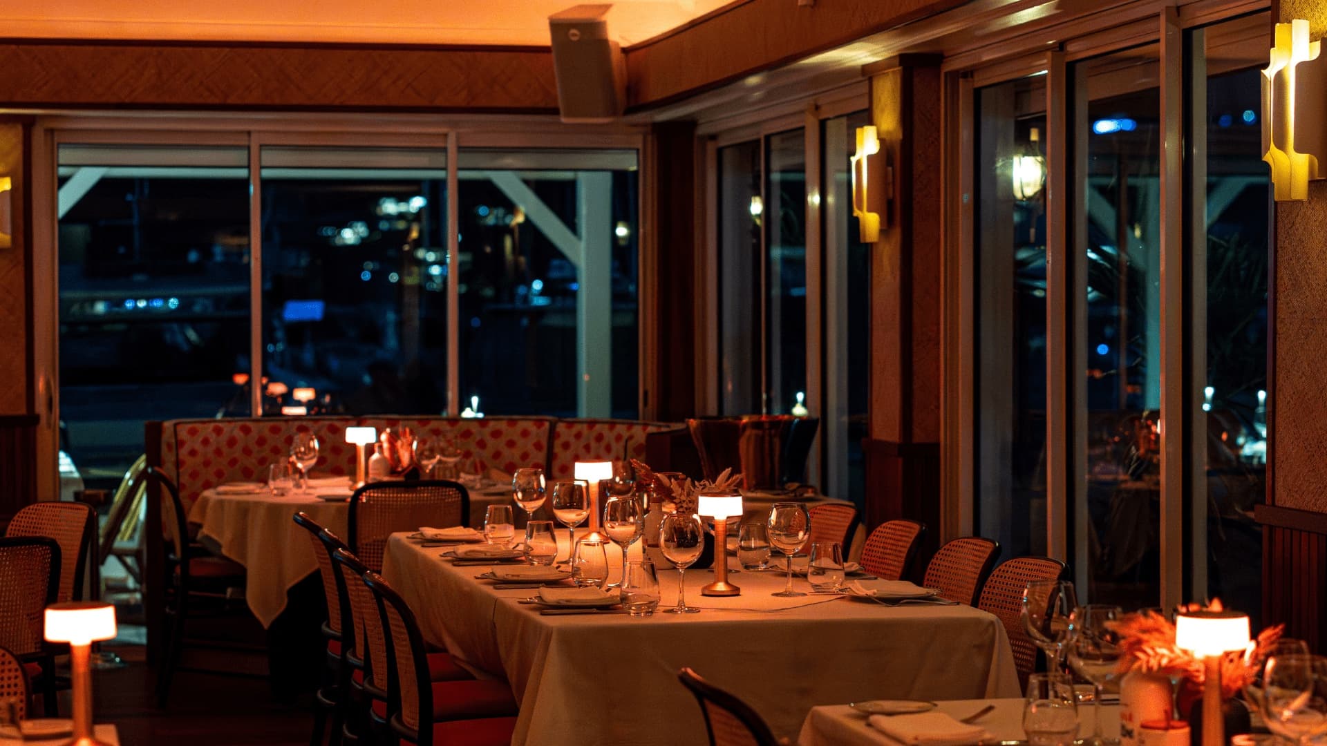 Bagatelle Saint-Barth's candle-lit room, Gustavia harbour behind