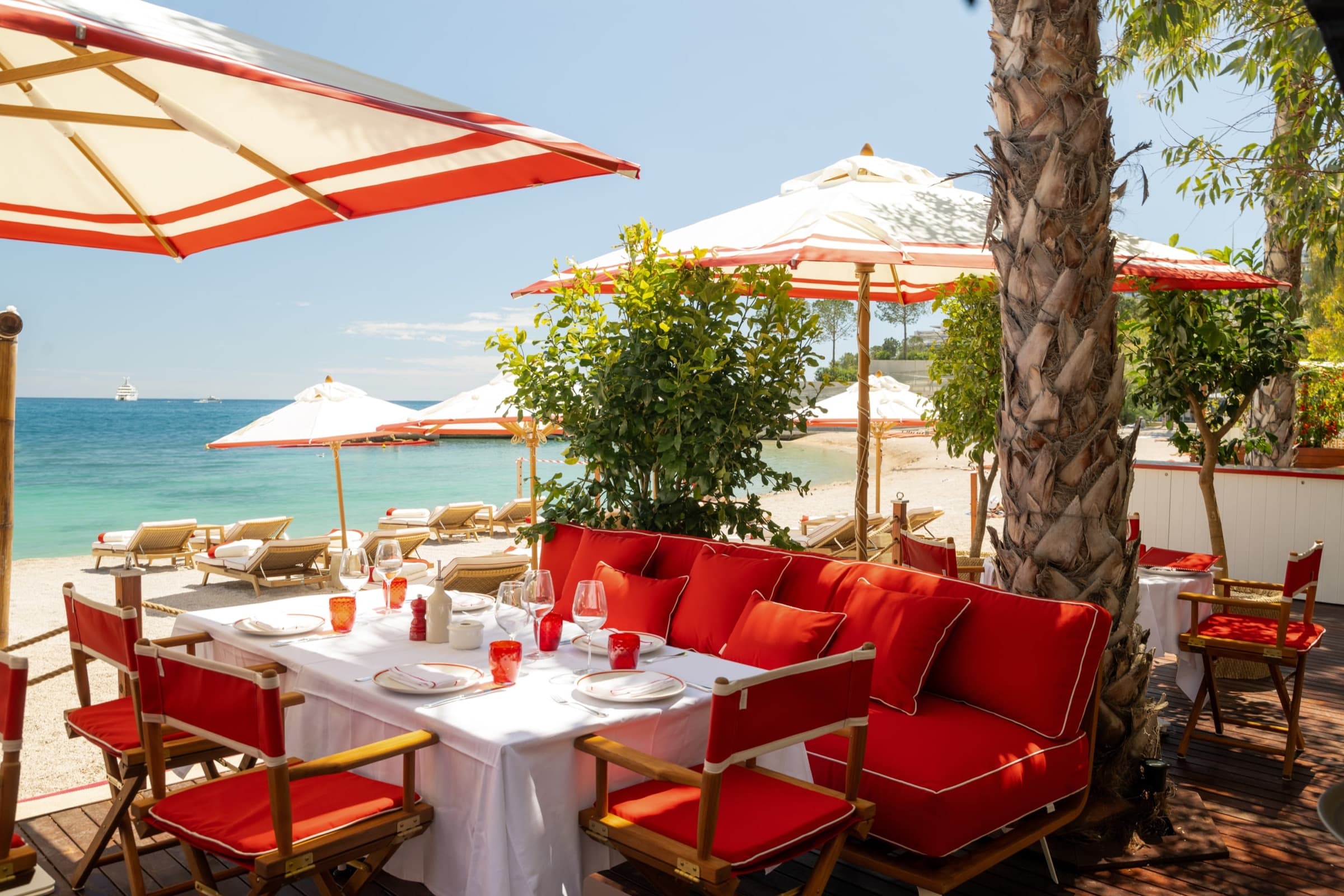 La Rose des Vents' striped parasols on Larvotto beach